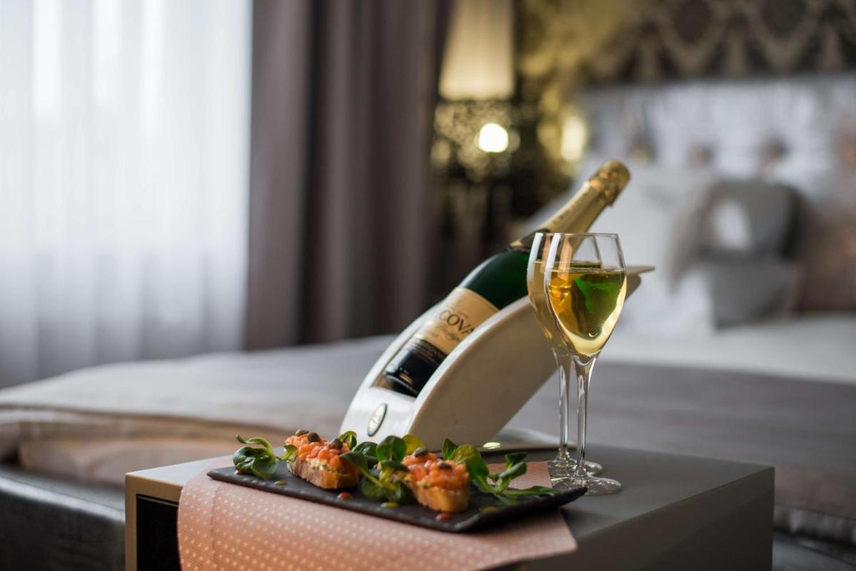 a bottle of champagne and a wine glass on a table at Radisson Blu Jaipur in Jaipur