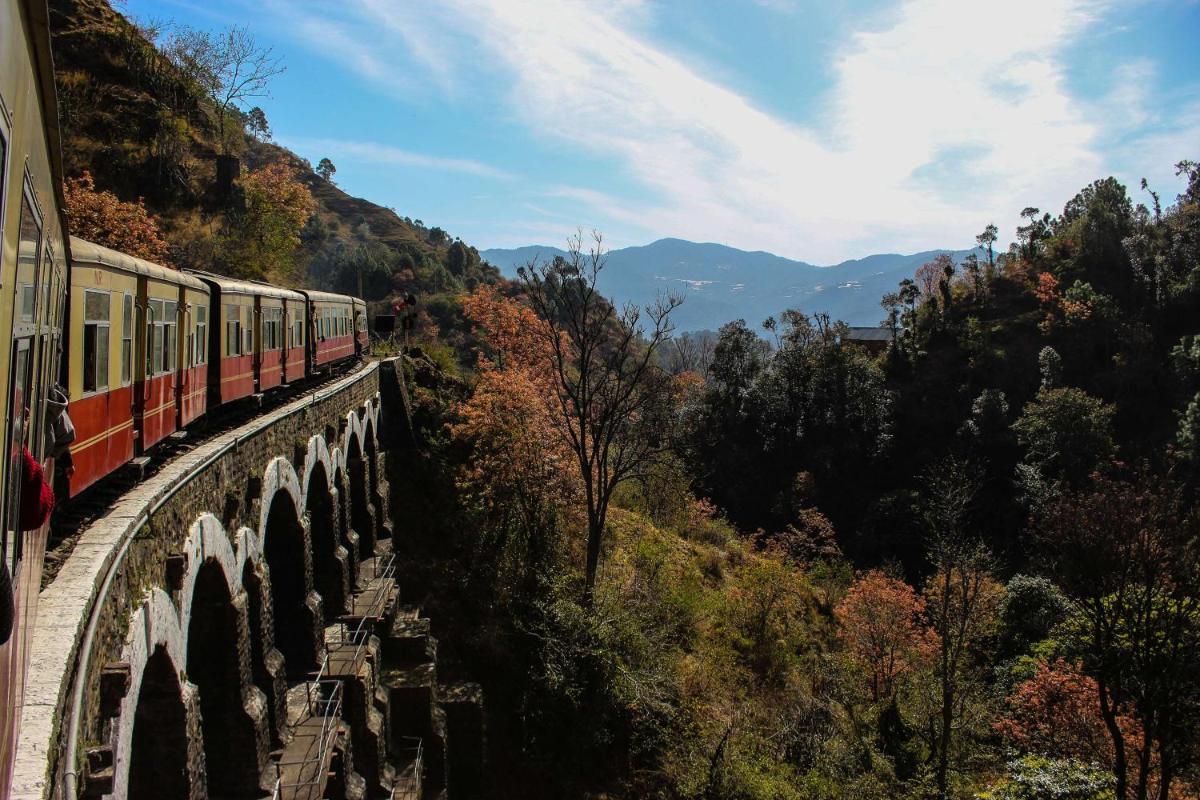 a train on a bridge over a mountain at Radisson Hotel Shimla in Shimla