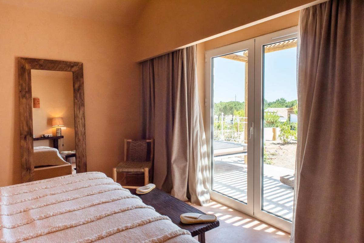 Uma cama ou camas num quarto em Independente Comporta