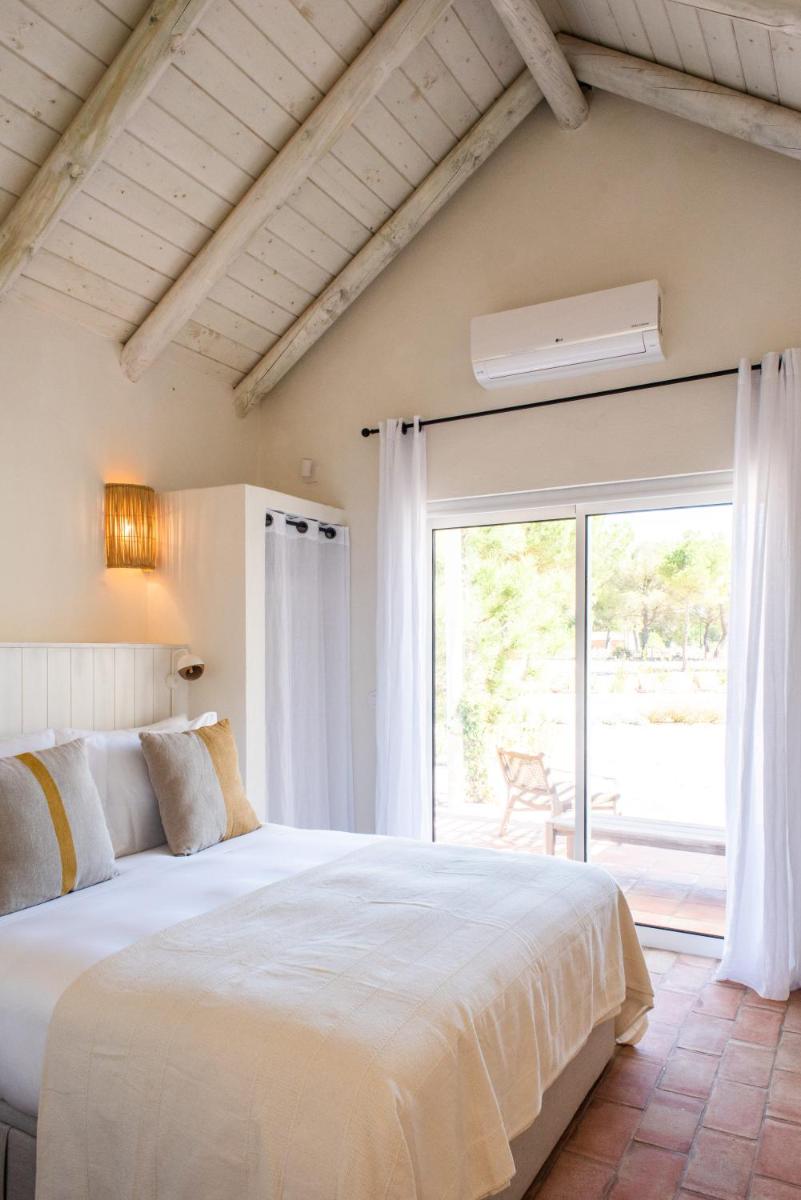 Uma cama ou camas num quarto em Independente Comporta
