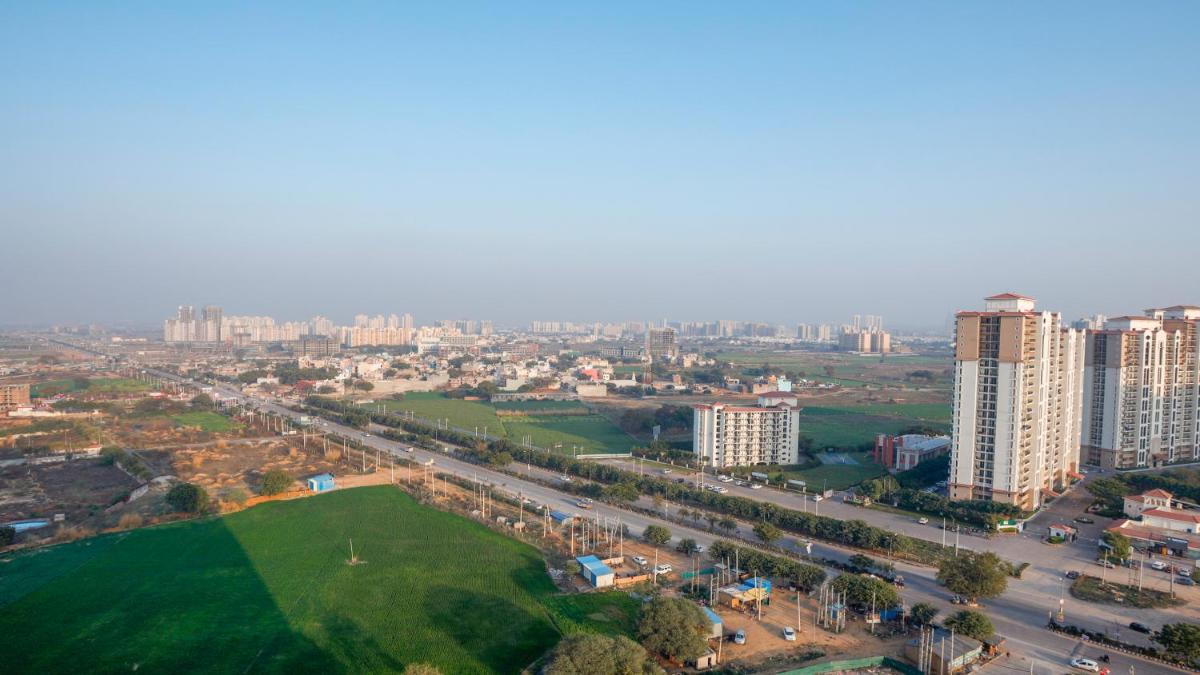 an aerial view of a city with tall buildings at Holiday Inn Gurugram Sector 90 by IHG in Gurgaon