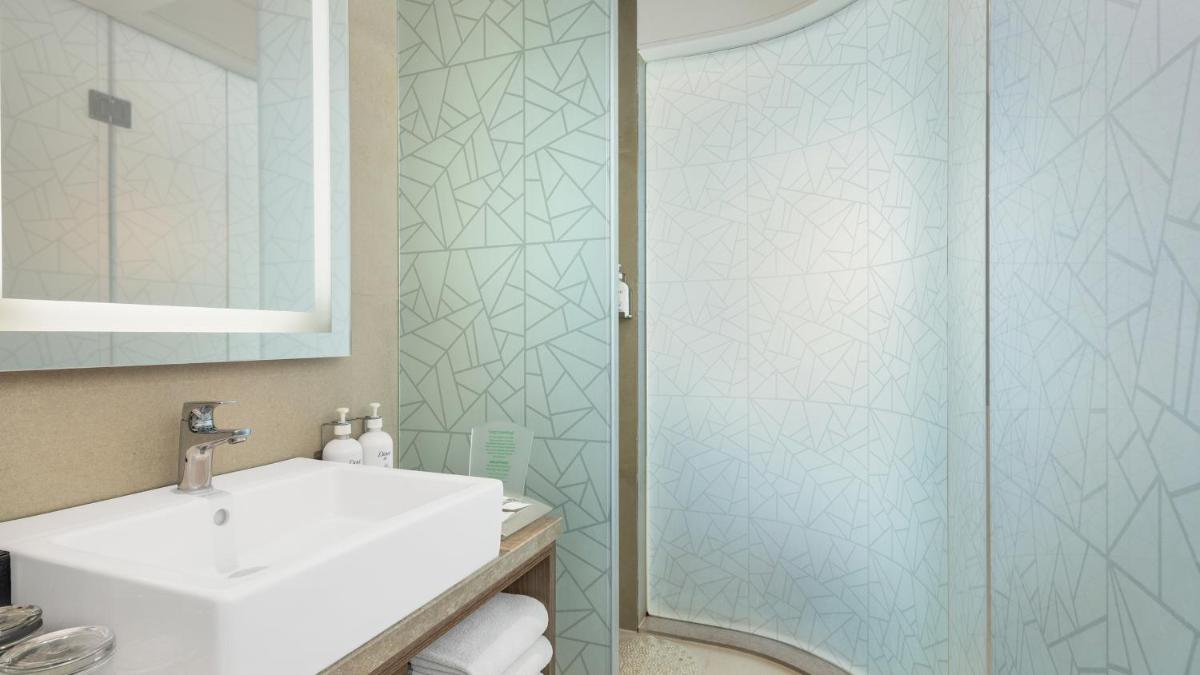 a bathroom with a sink and a shower at Holiday Inn Gurugram Sector 90 by IHG in Gurgaon