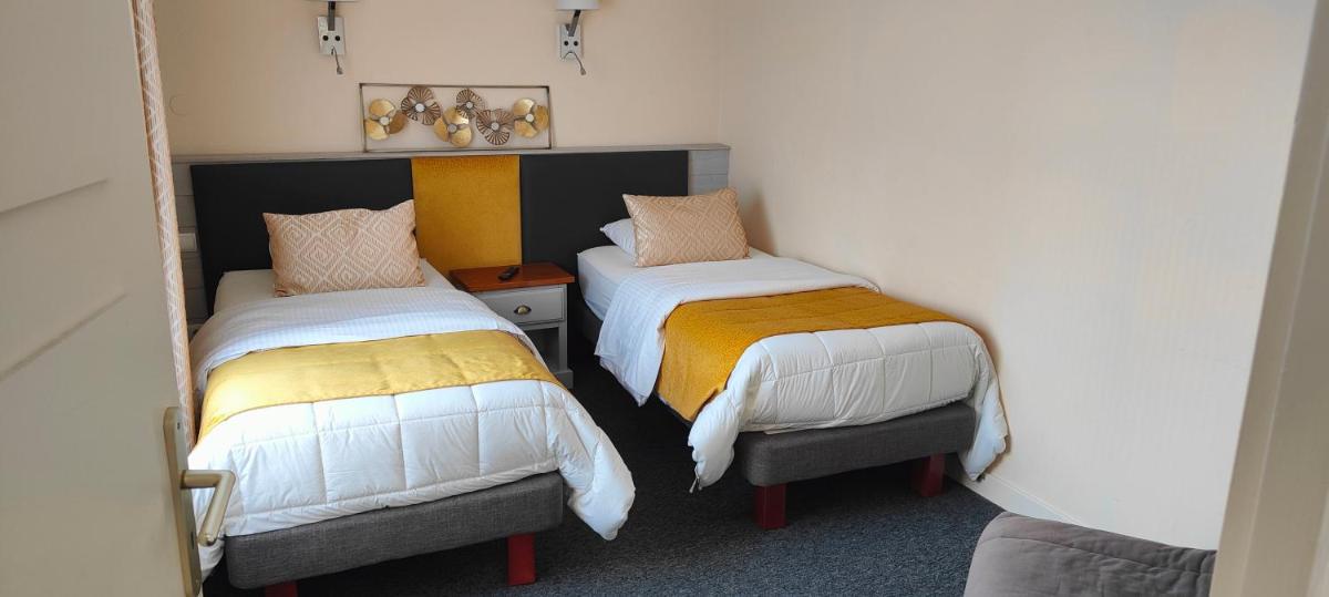 Un ou plusieurs lits dans un hébergement de l'établissement Hôtel Spa & Restaurant Ô Pervenches