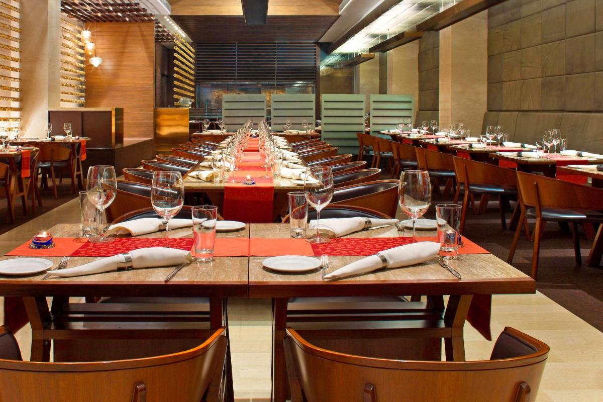 a large dining room with a long table and chairs at The Westin Hyderabad Mindspace in Hyderabad