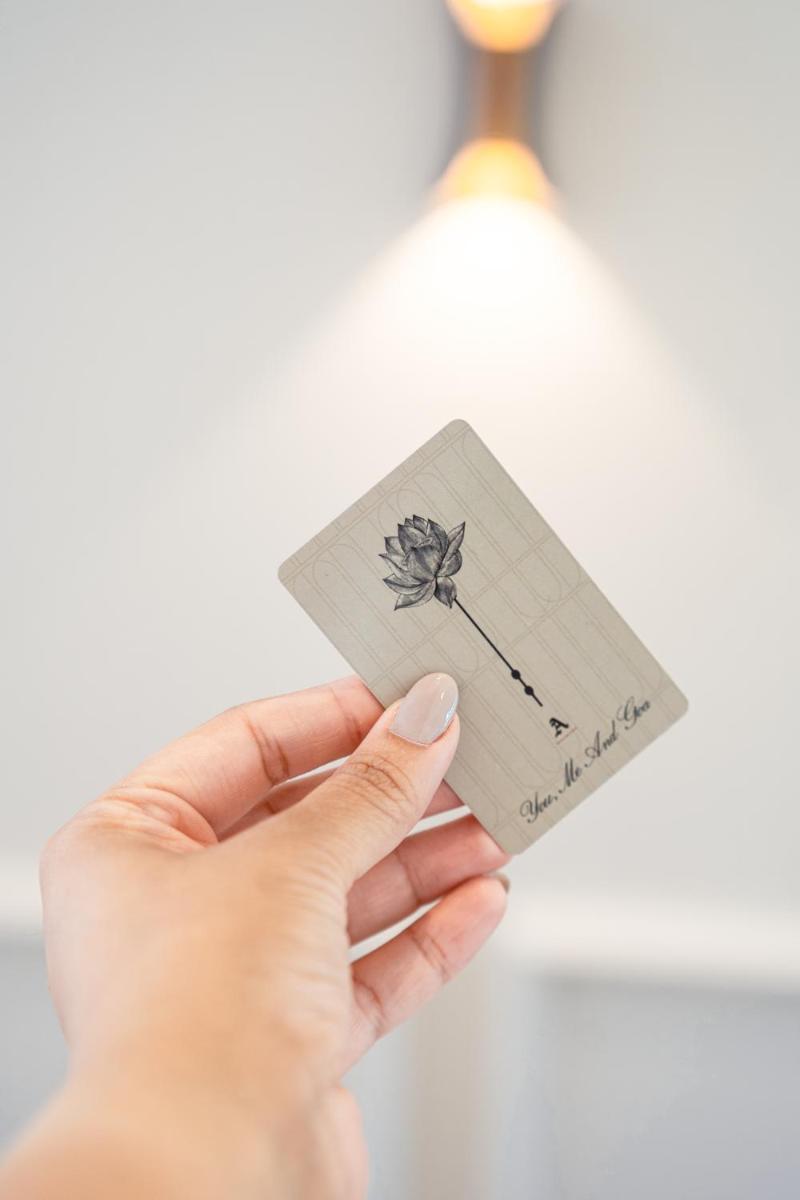 a hand holding a card with a flower on it at The Astor - All Suites Hotel Candolim Goa in Candolim a hand holding a card with a flower on it at The Astor - All Suites Hotel Candolim Goa in Candolim