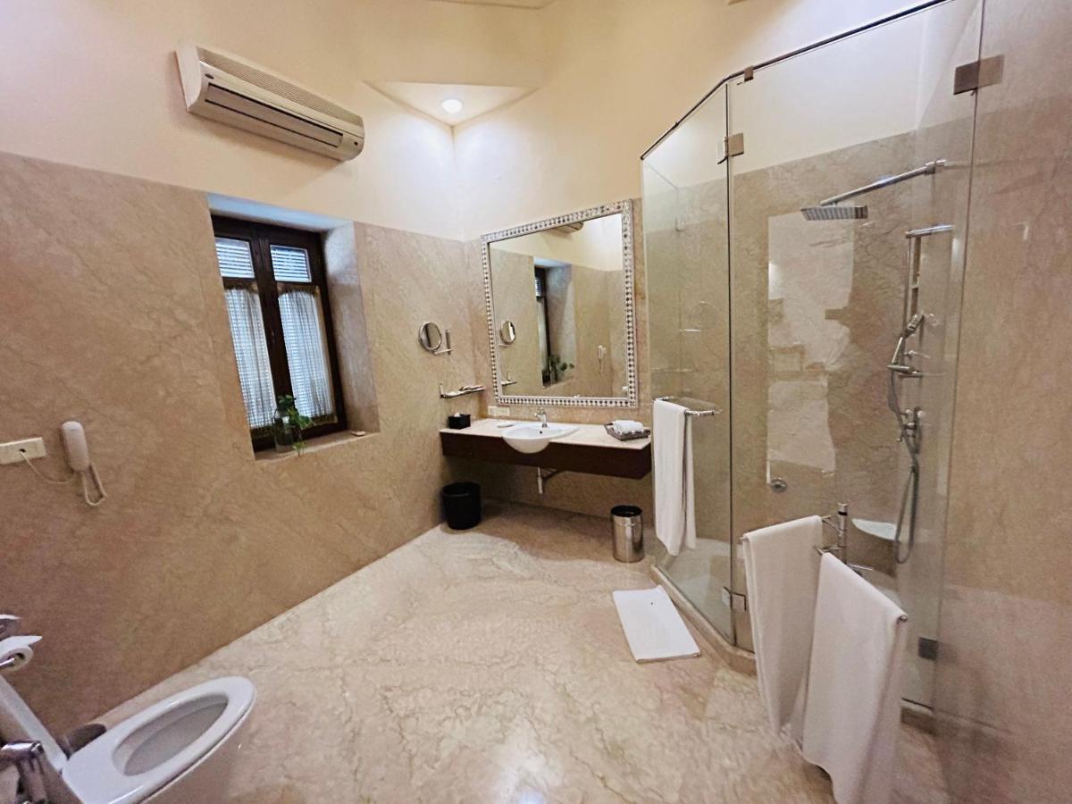 a bathroom with a toilet and a sink and a shower at The Lalit Laxmi Vilas Palace in Udaipur