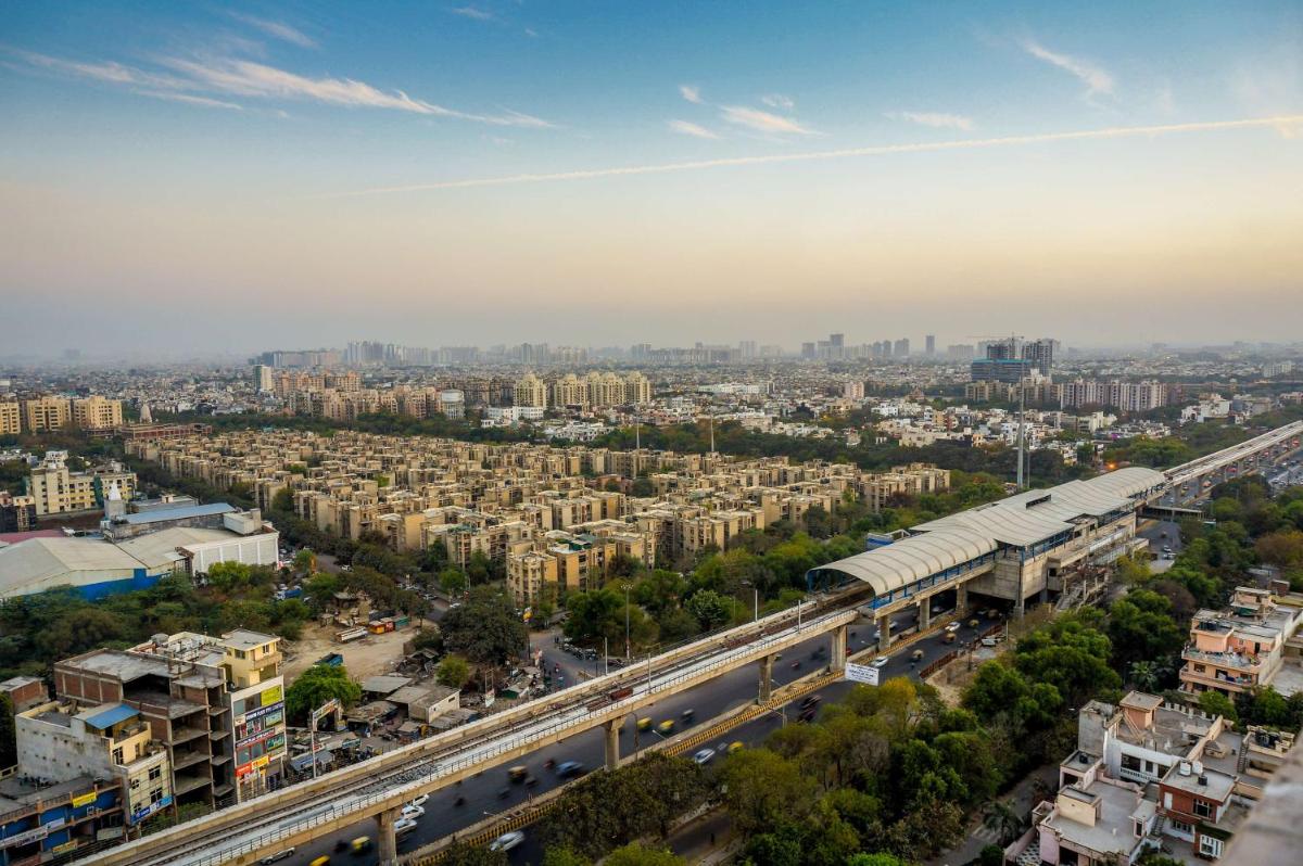 an aerial view of a city with a train station at Park Plaza Shahdara in New Delhi an aerial view of a city with a train station at Park Plaza Shahdara in New Delhi