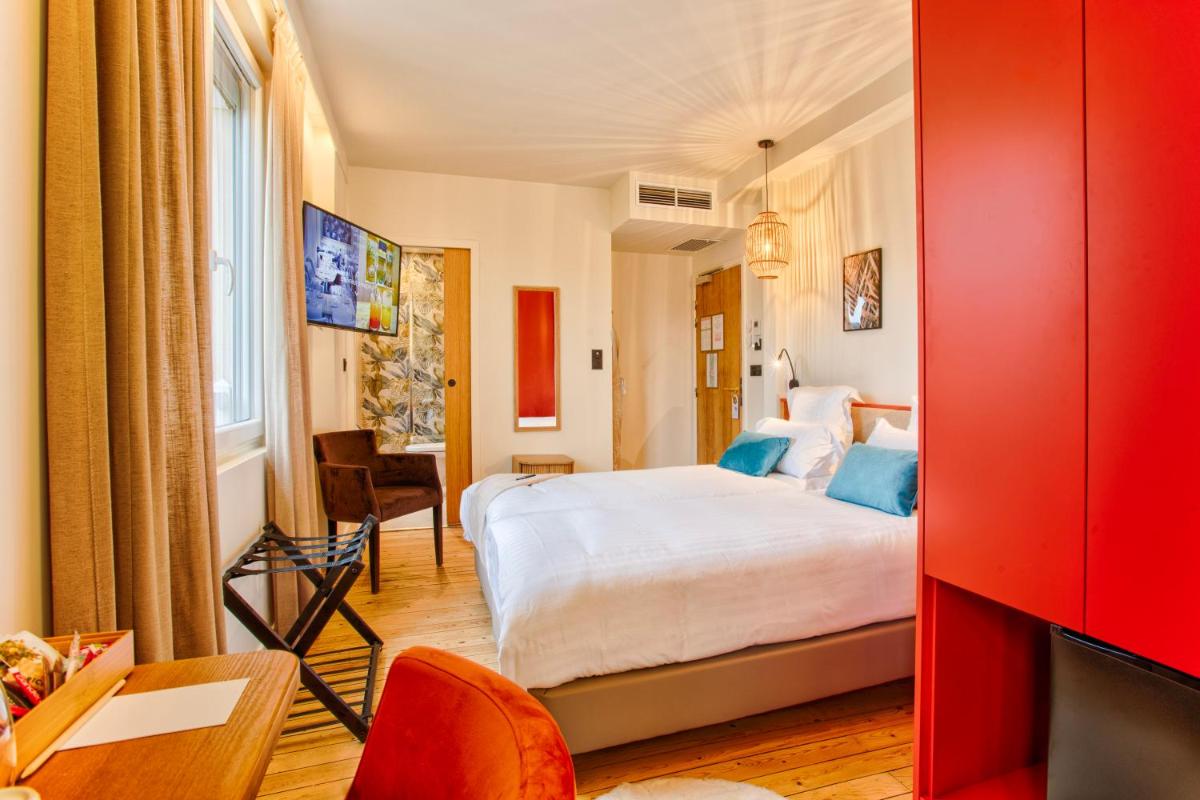 Un ou plusieurs lits dans un hébergement de l'établissement Le Castel Cabourg hôtel & SPA- Restaurant La Calypso
