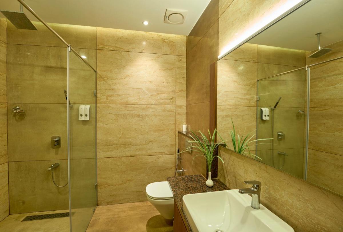 a bathroom with a toilet and a sink and a shower at Elephant Passage in Munnar