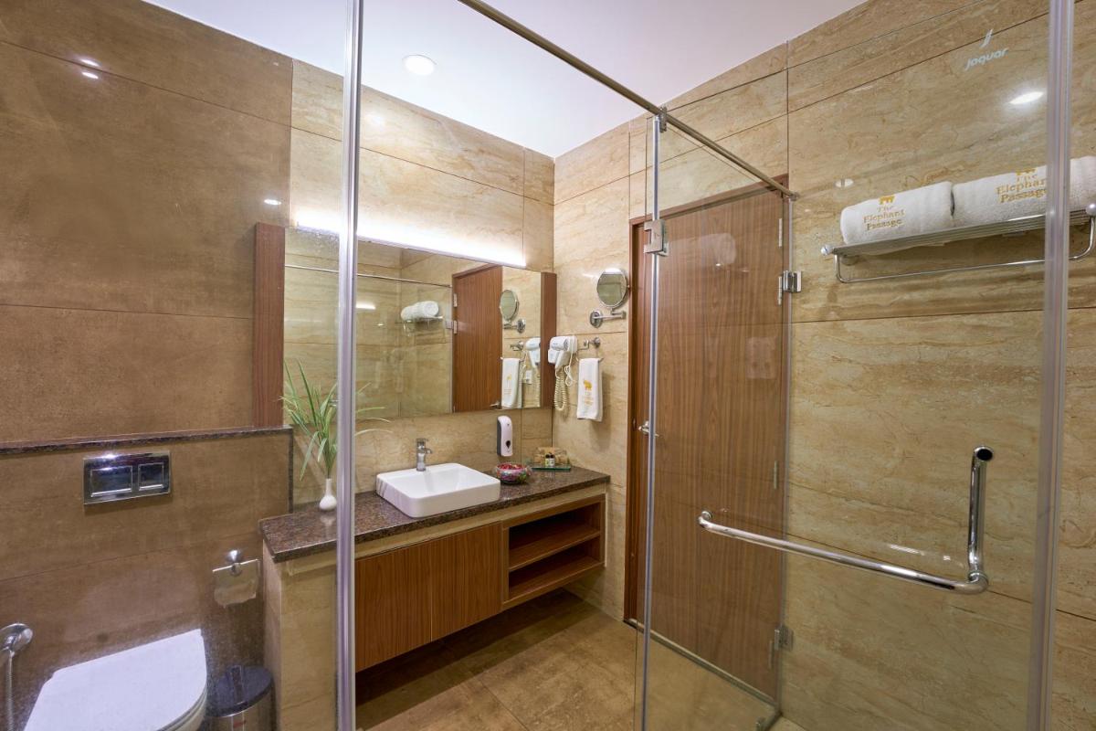 a bathroom with a sink and a glass shower at Elephant Passage in Munnar