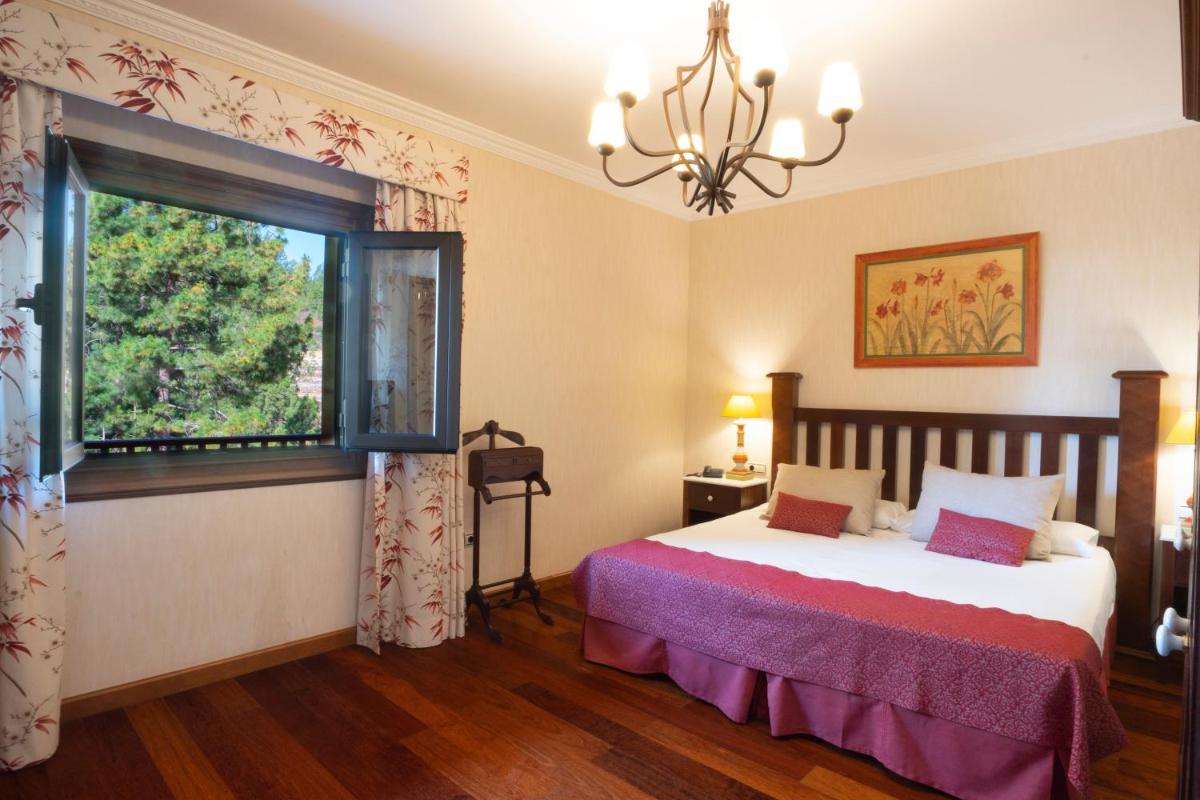 Cama o camas de una habitación en Hotel Spa Villalba