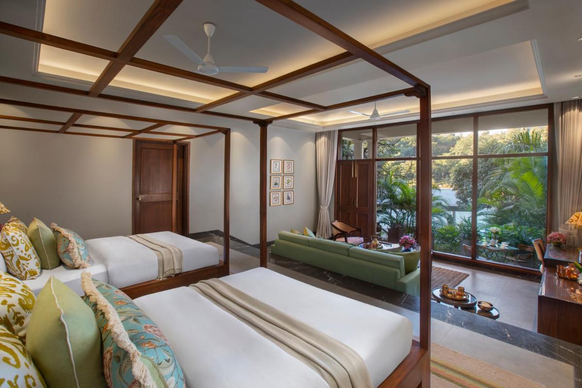 a hotel room with two beds and a window at Anand Kashi by the Ganges Rishikesh - IHCL Seleqtions in Rishīkesh