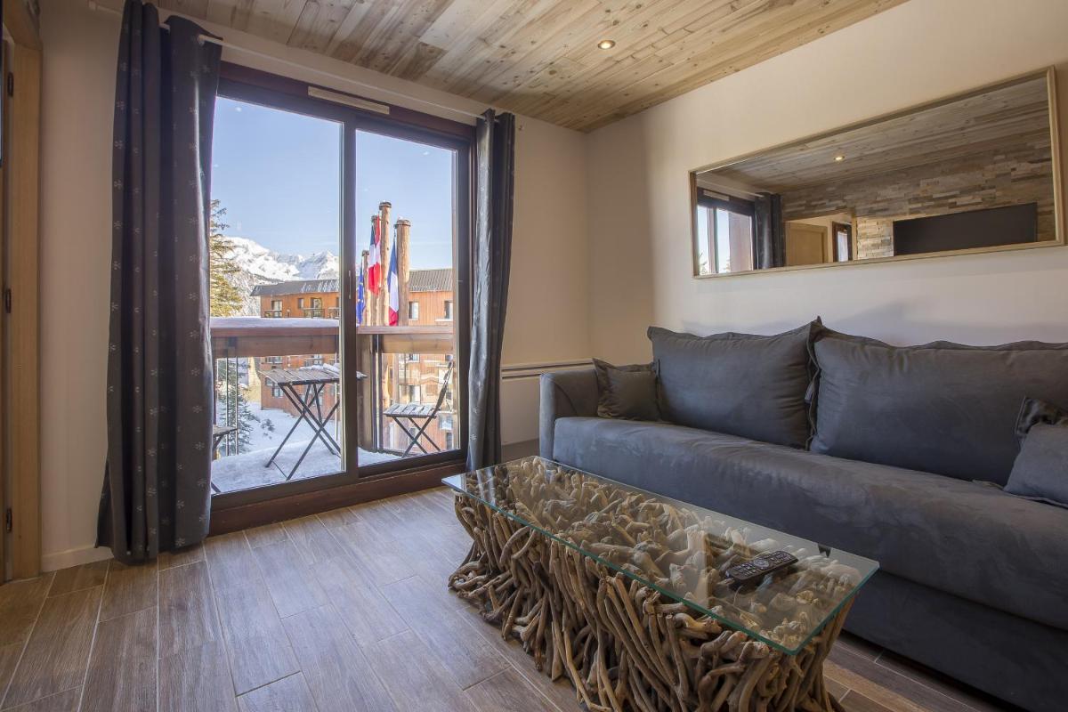 Coin salon dans l'établissement Résidence Le Domaine du Jardin Alpin - Courchevel 1850