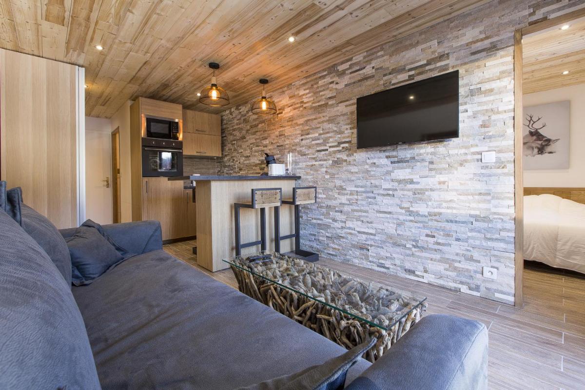 Télévision ou salle de divertissement dans l'établissement Résidence Le Domaine du Jardin Alpin - Courchevel 1850