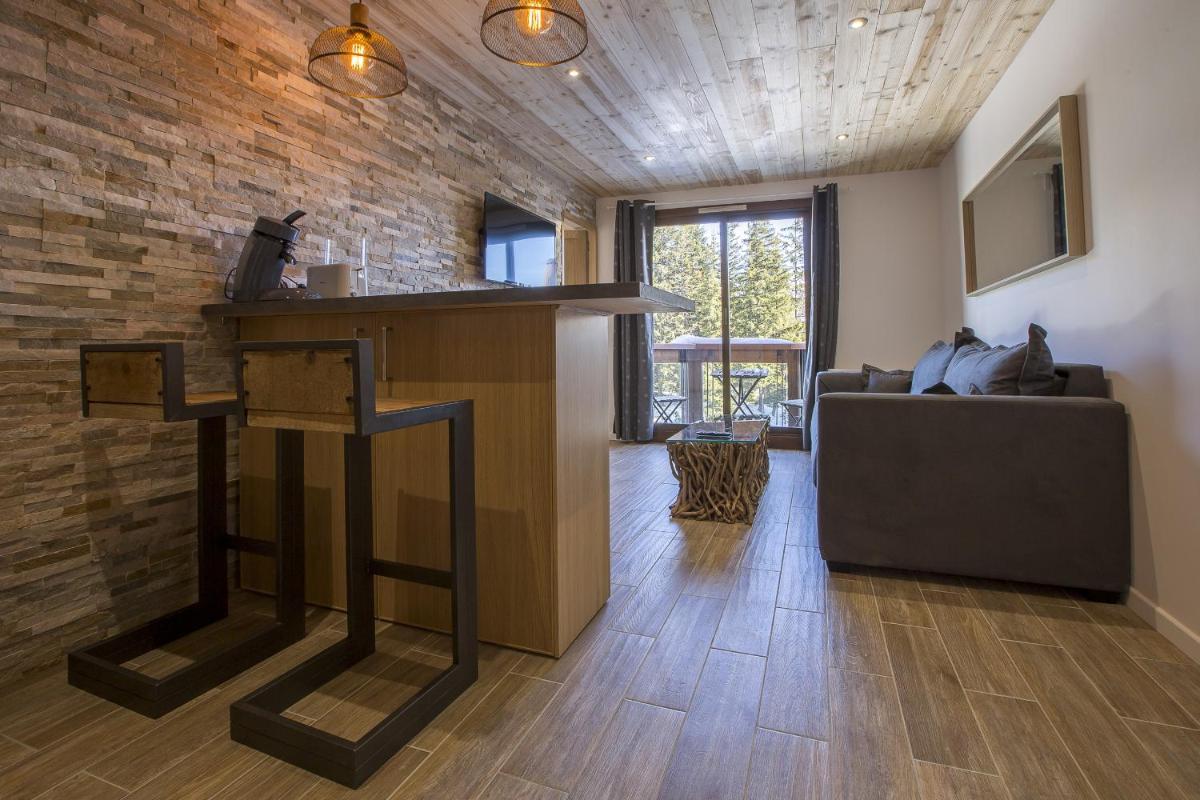 Télévision ou salle de divertissement dans l'établissement Résidence Le Domaine du Jardin Alpin - Courchevel 1850