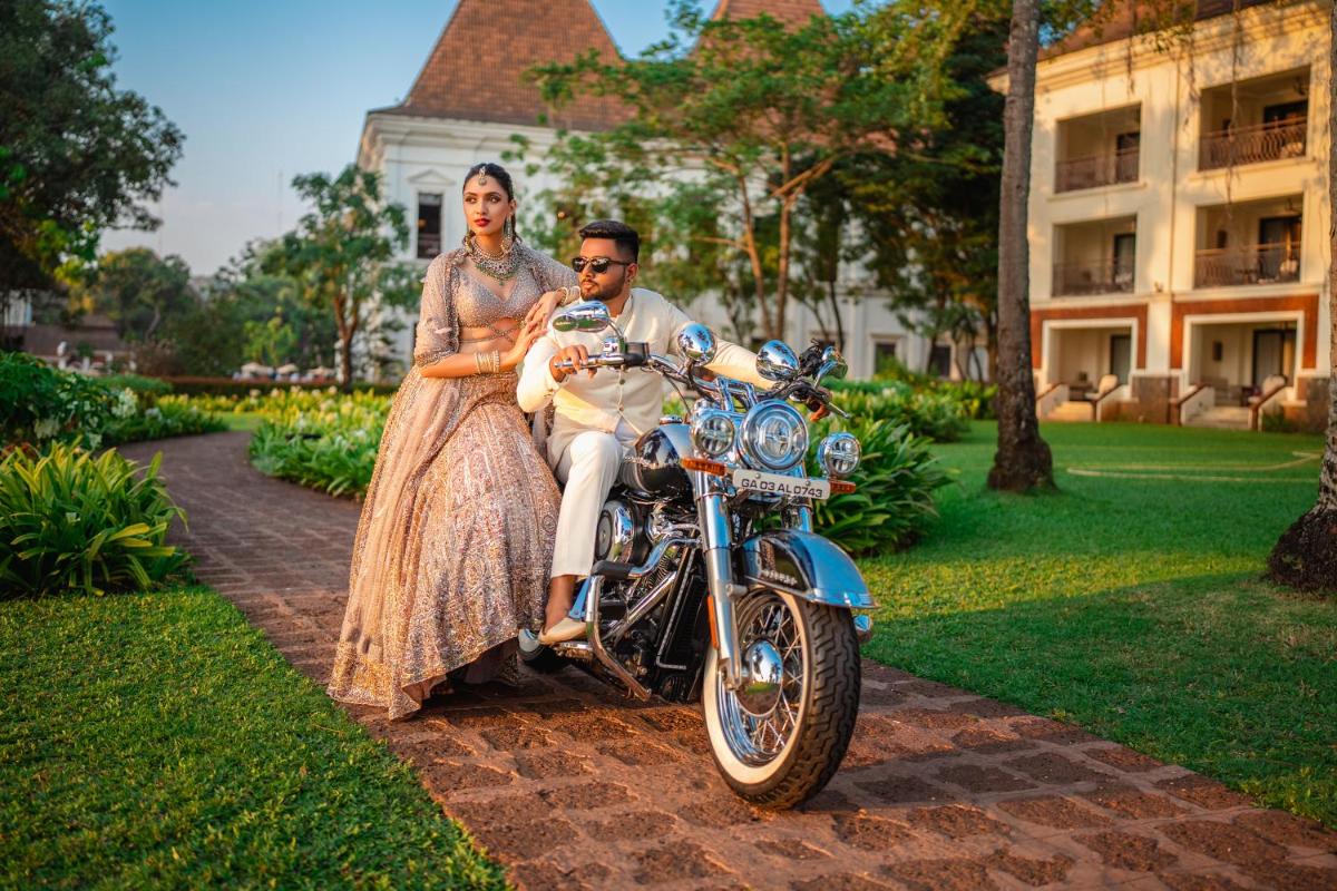 a man and a woman sitting on a motorcycle at Grand Hyatt Goa in Panaji a man and a woman sitting on a motorcycle at Grand Hyatt Goa in Panaji