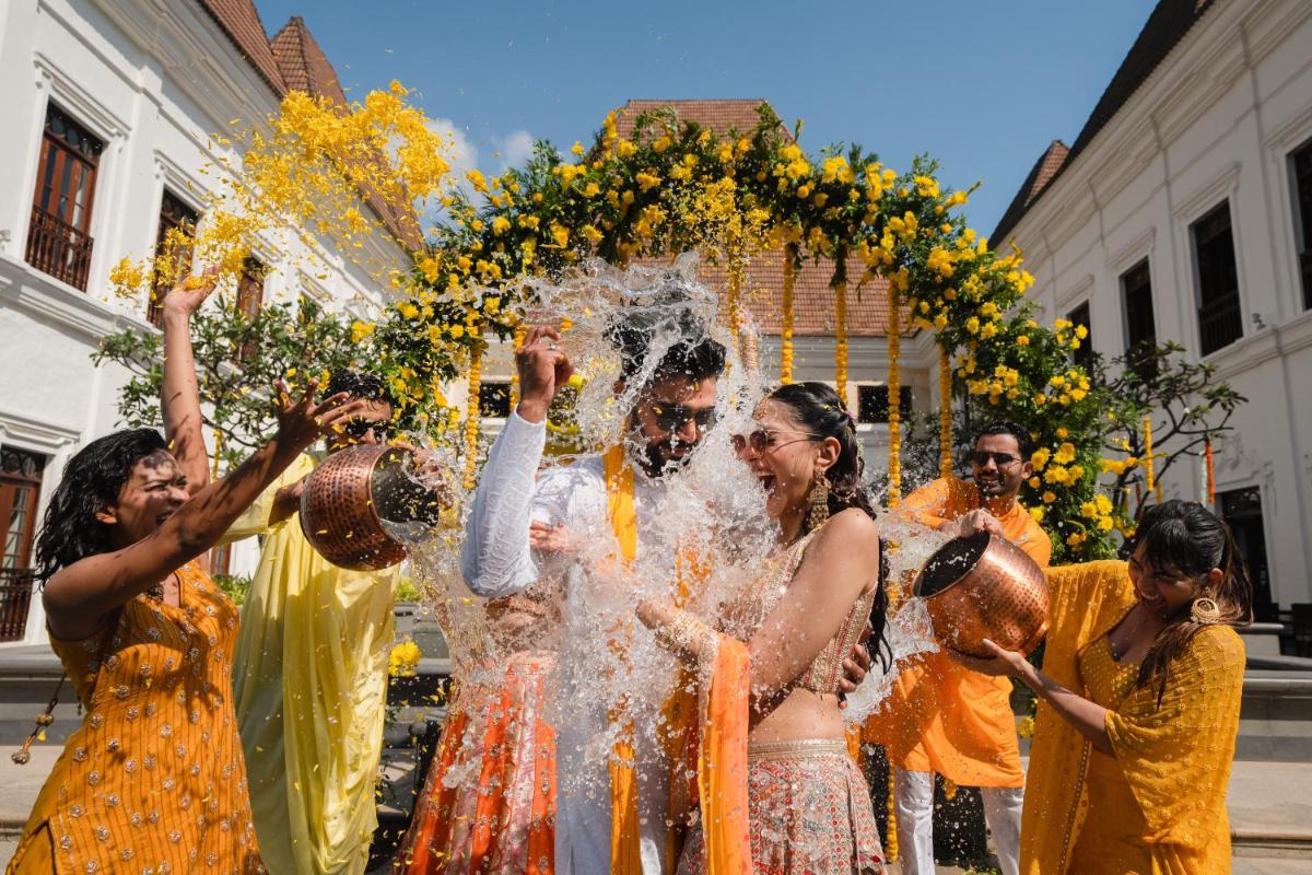 a group of people playing with water in the street at Grand Hyatt Goa in Panaji a group of people playing with water in the street at Grand Hyatt Goa in Panaji