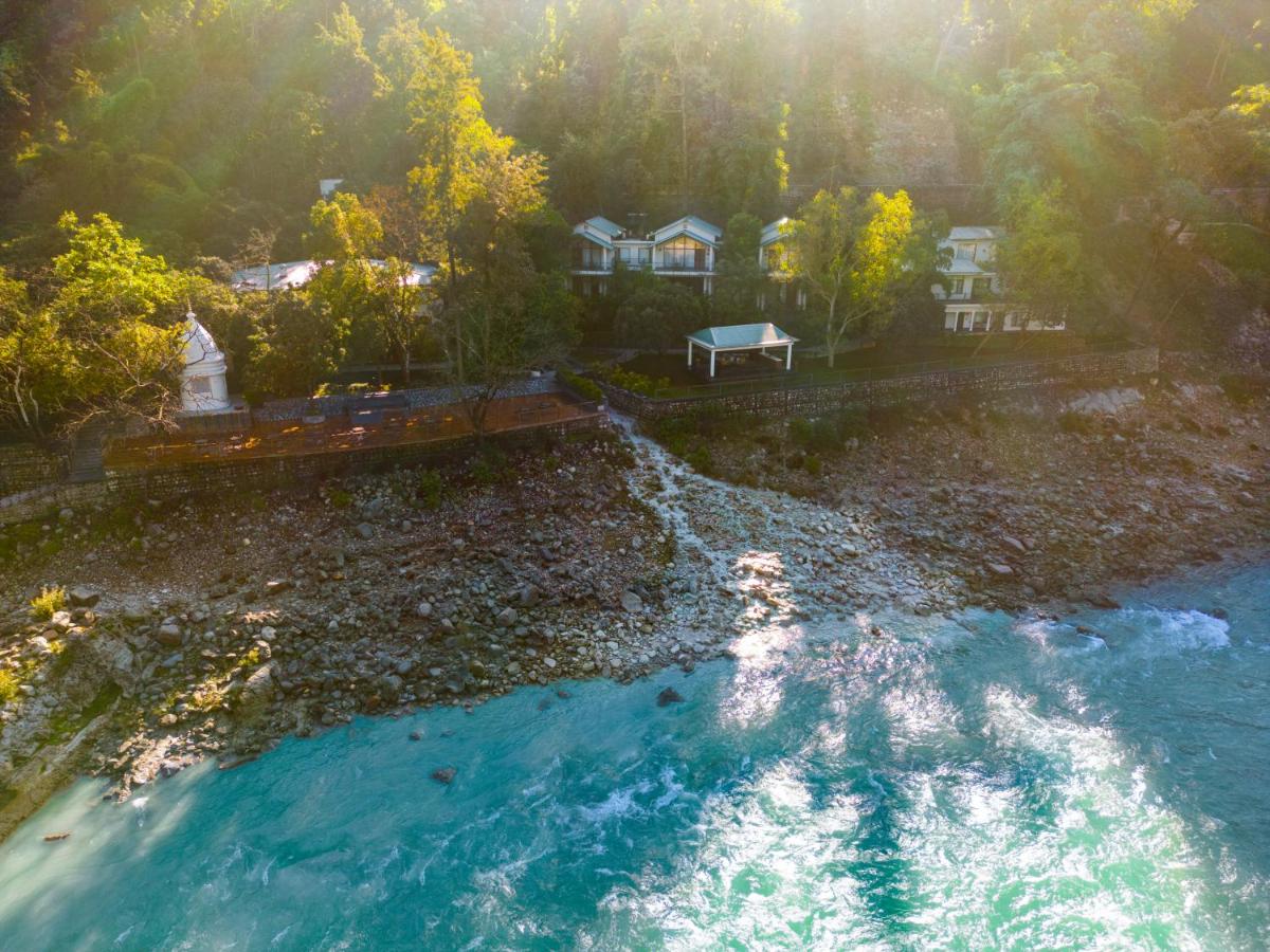 an aerial view of a river with a house at Anand Kashi by the Ganges Rishikesh - IHCL Seleqtions in Rishīkesh