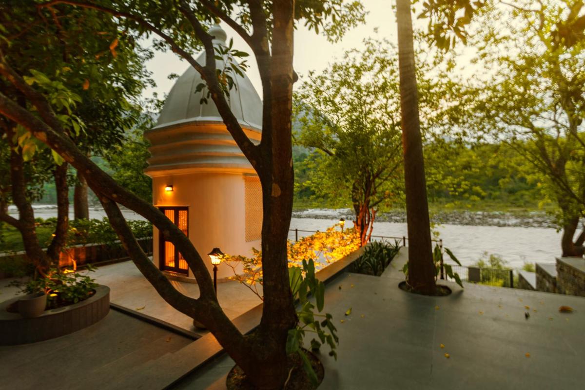 a building with a dome in the middle of trees at Anand Kashi by the Ganges Rishikesh - IHCL Seleqtions in Rishīkesh