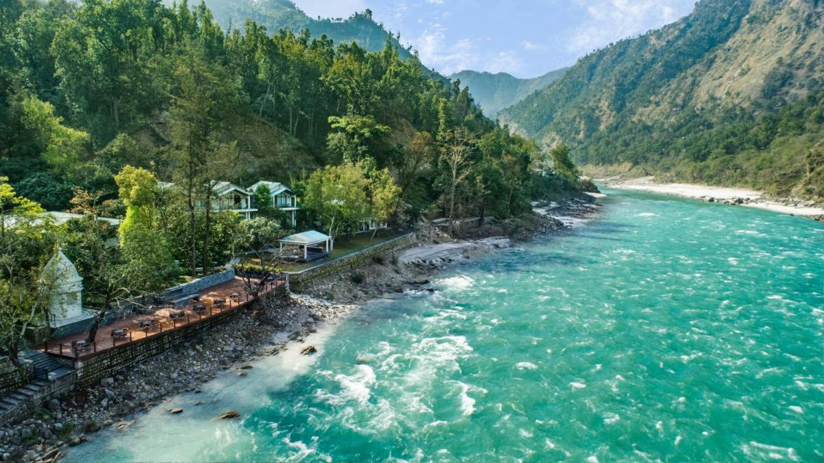 an aerial view of a river with mountains in the background at Anand Kashi by the Ganges Rishikesh - IHCL Seleqtions in Rishīkesh