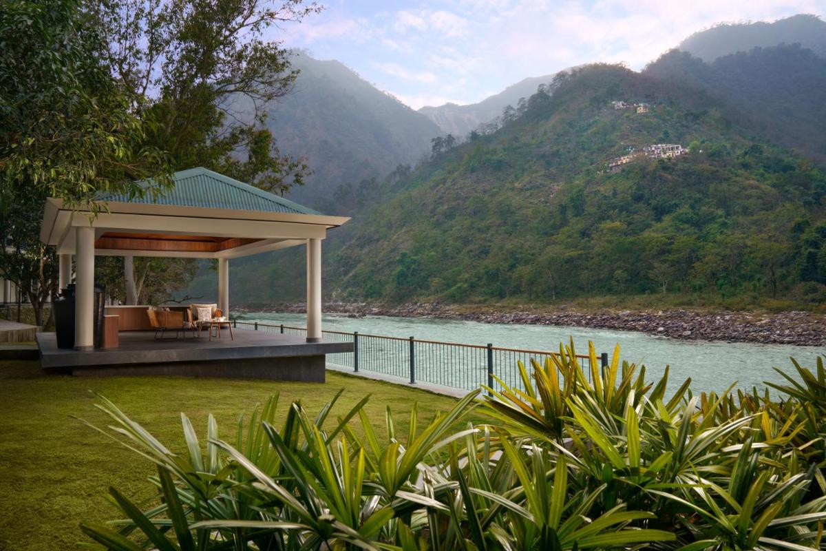 a gazebo with a view of a river and mountains at Anand Kashi by the Ganges Rishikesh - IHCL Seleqtions in Rishīkesh