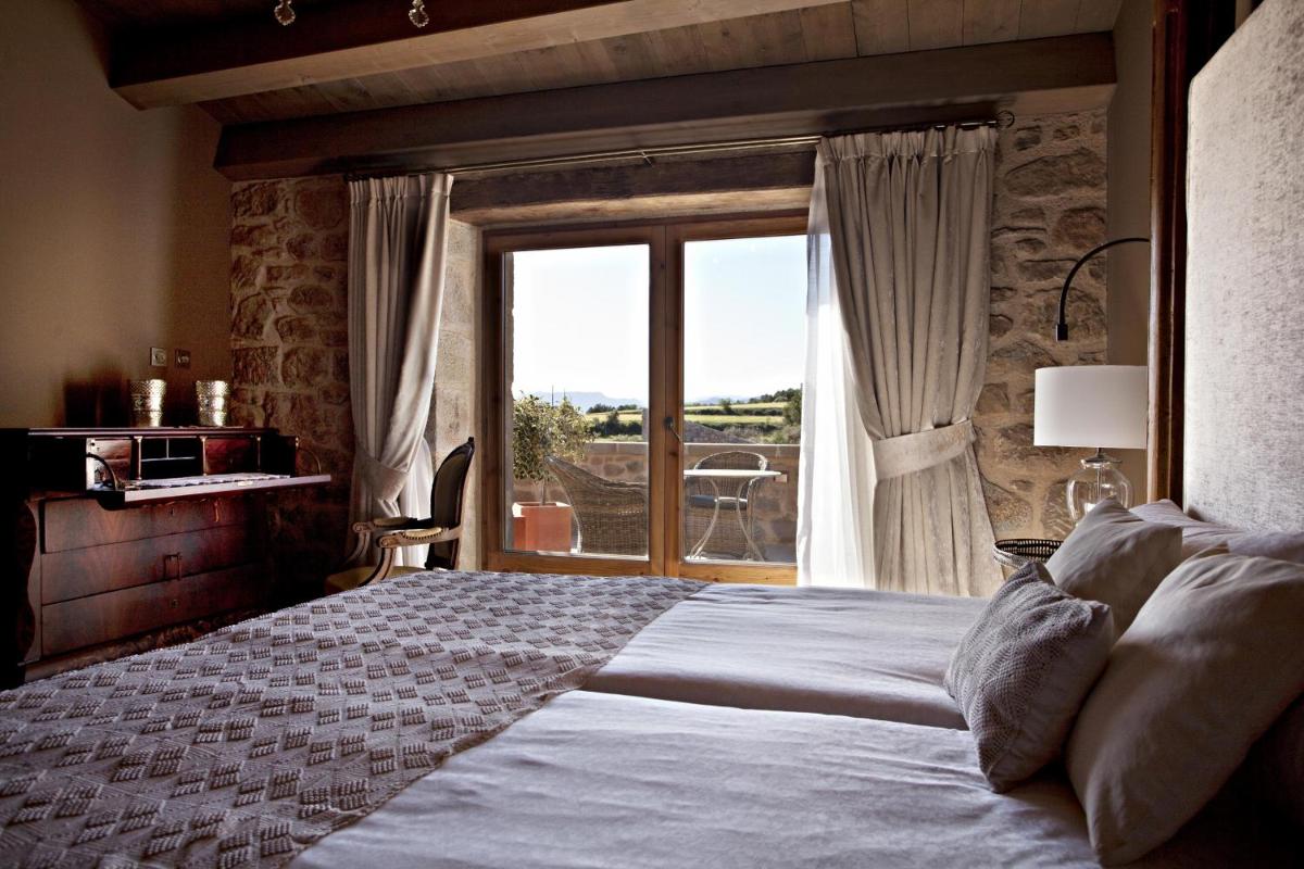 Cama o camas de una habitación en La Vella Farga Hotel