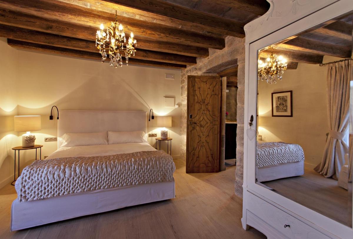 Cama o camas de una habitación en La Vella Farga Hotel