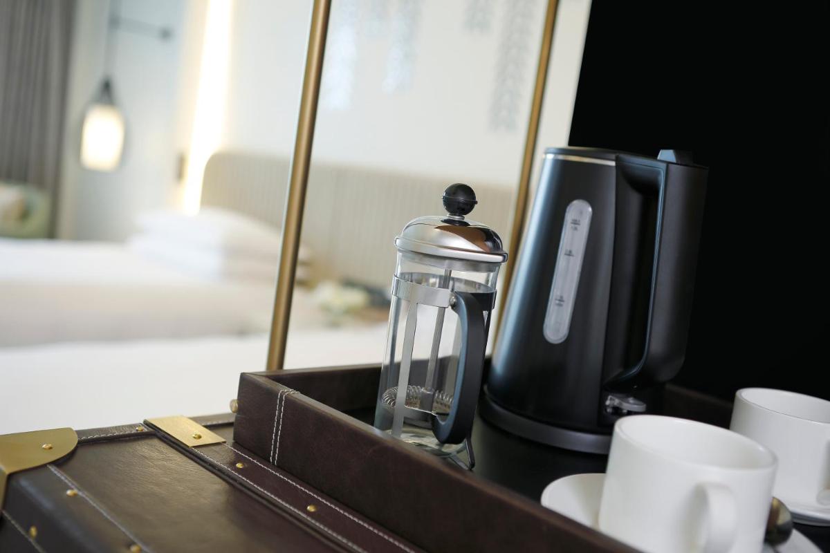 a coffee maker and cups sitting on a table at InterContinental Jaipur Tonk Road by IHG in Jaipur