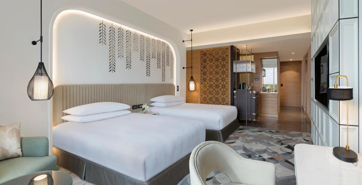 a hotel room with two beds and a living room at InterContinental Jaipur Tonk Road by IHG in Jaipur