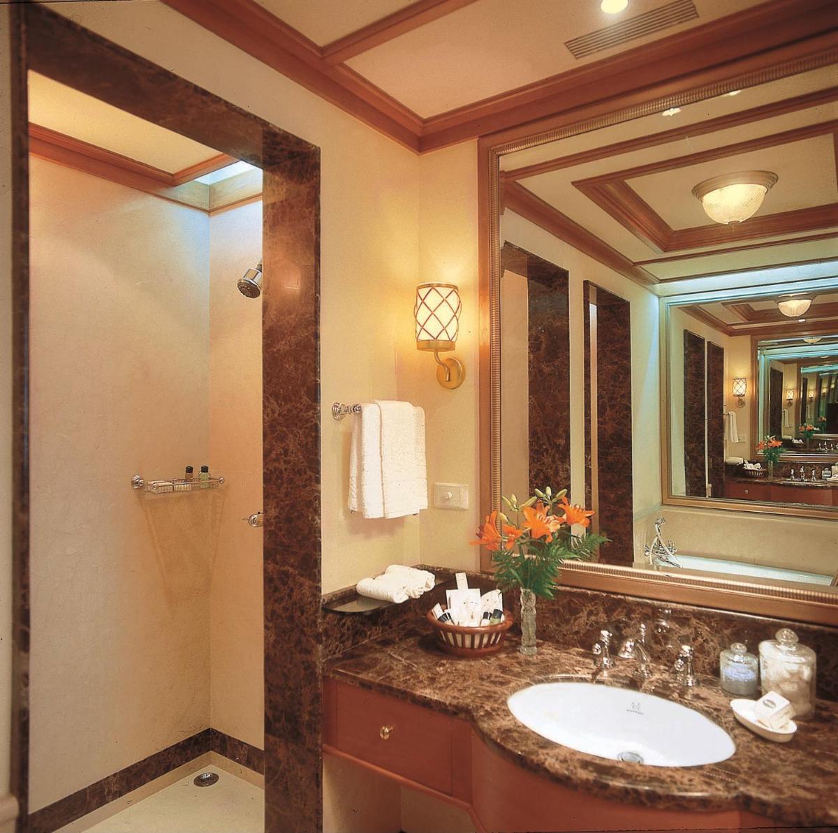 a bathroom with a sink and a mirror at Wildflower Hall, An Oberoi Resort, Shimla in Shimla