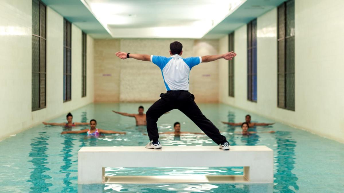 a man standing on a block in a swimming pool at Grand Hyatt Goa in Panaji a man standing on a block in a swimming pool at Grand Hyatt Goa in Panaji