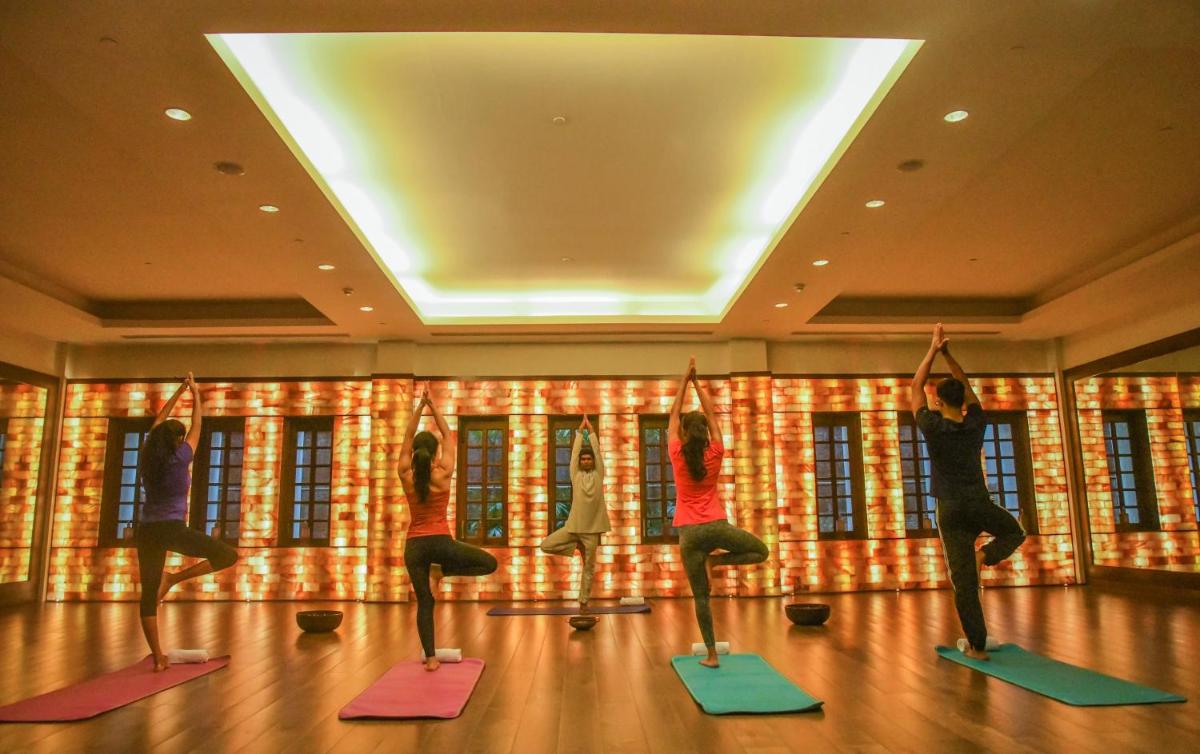 a group of people doing yoga in a room at Grand Hyatt Goa in Panaji a group of people doing yoga in a room at Grand Hyatt Goa in Panaji