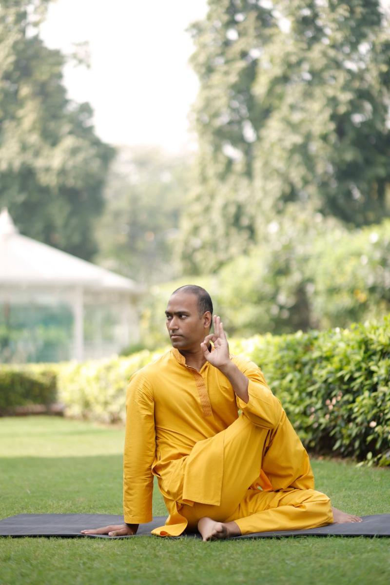a man sitting on the grass talking on a cell phone at The Imperial, New Delhi in New Delhi a man sitting on the grass talking on a cell phone at The Imperial, New Delhi in New Delhi