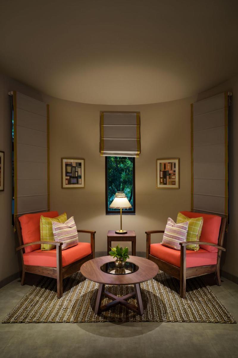 a living room with two couches and a coffee table at Anand Kashi by the Ganges Rishikesh - IHCL Seleqtions in Rishīkesh