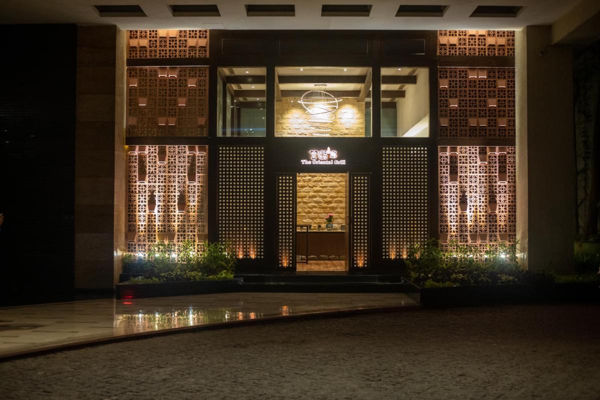 a building lit up at night with lights at Hyatt Pune in Pune