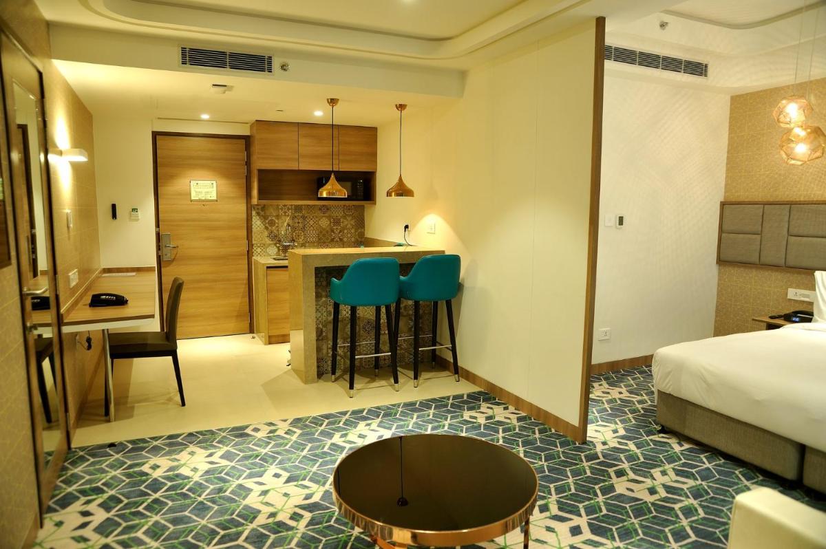 a hotel room with a bed and a kitchen at Holiday Inn Gurugram Sector 90 by IHG in Gurgaon