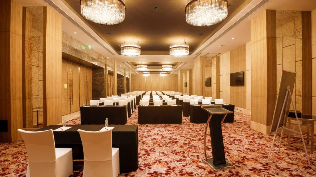 a large banquet hall with tables and chairs at Holiday Inn Gurugram Sector 90 by IHG in Gurgaon