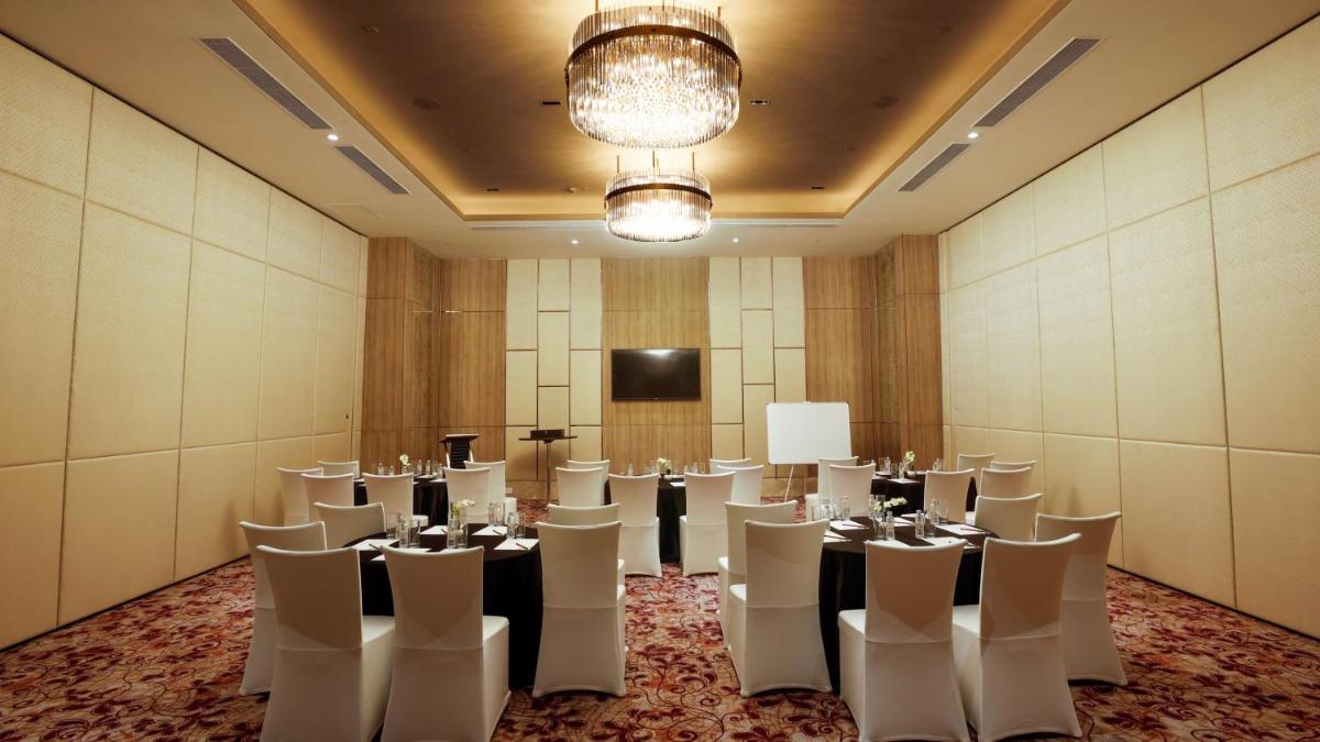 a conference room with tables and chairs and a podium at Holiday Inn Gurugram Sector 90 by IHG in Gurgaon