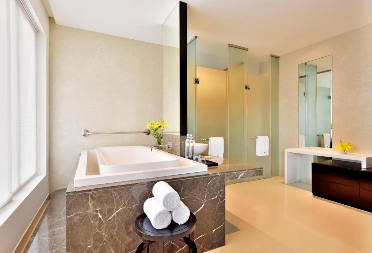 a bathroom with a tub and a sink at The Westin Hyderabad Mindspace in Hyderabad