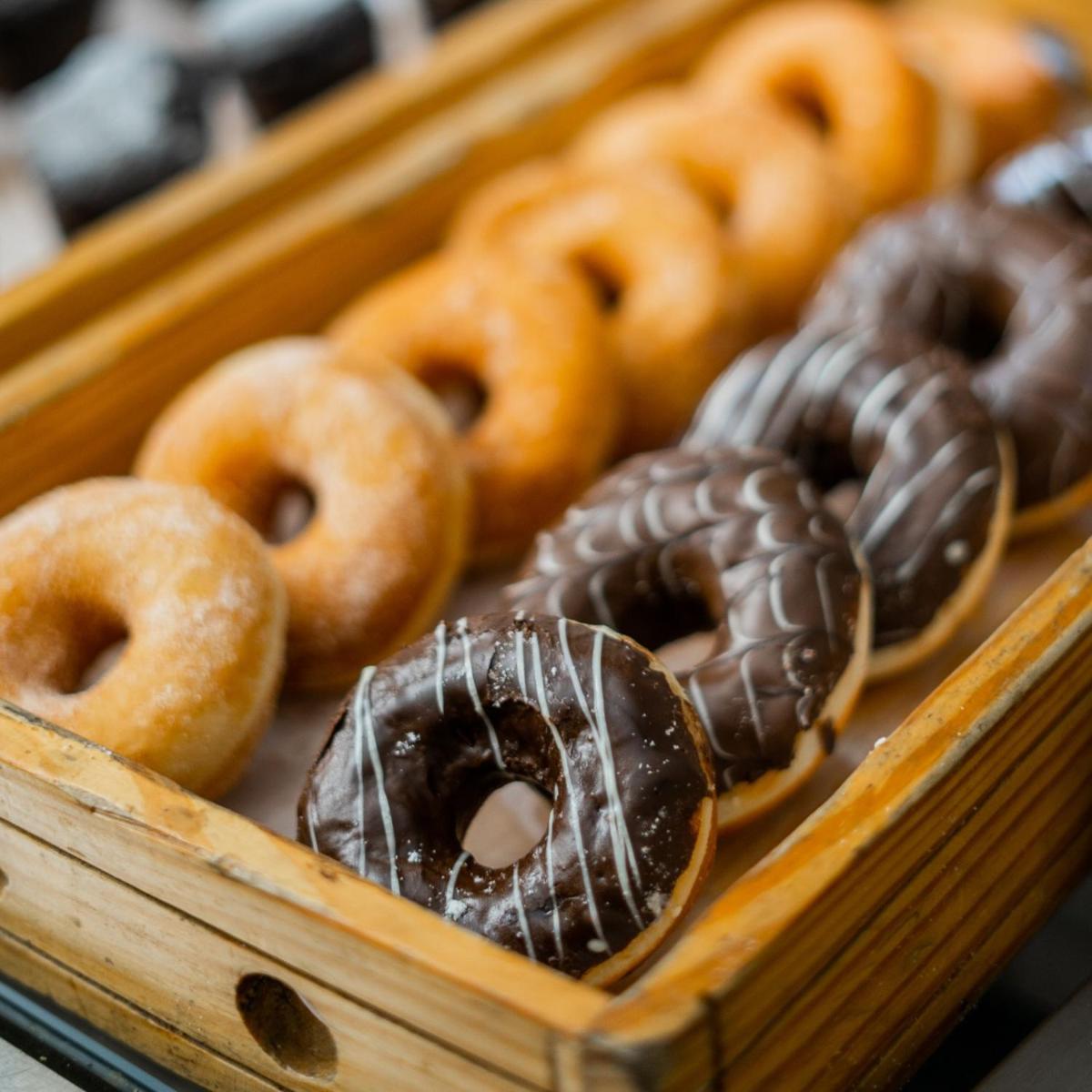 a wooden box filled with different types of donuts at Marriott Suites Pune in Pune