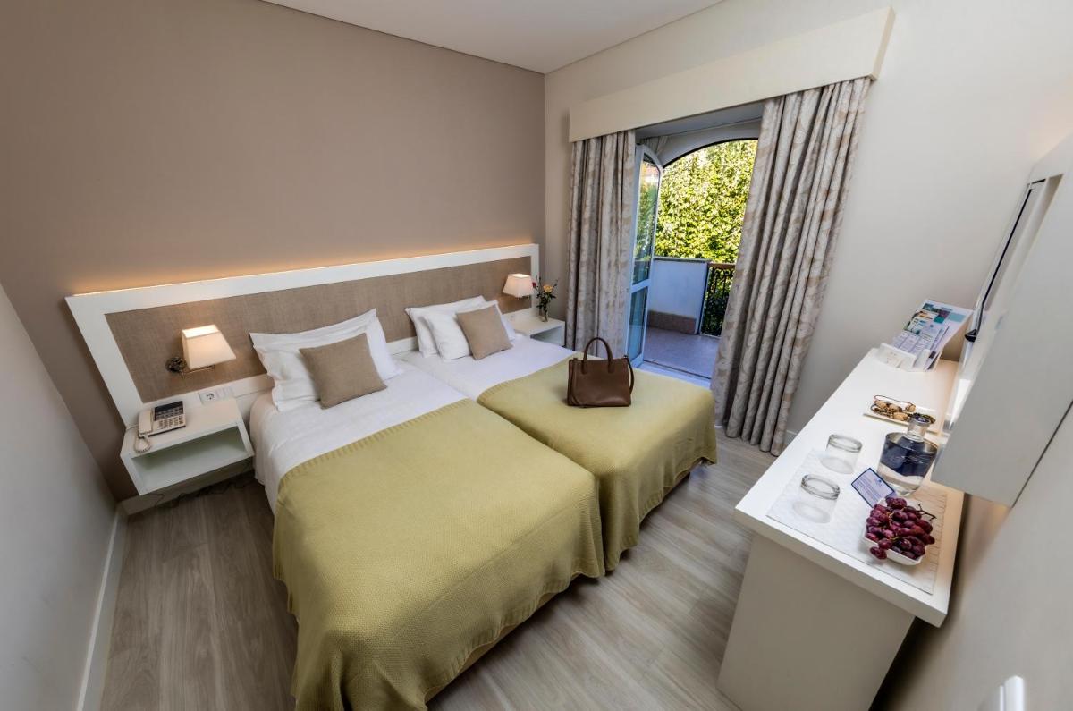 Uma cama ou camas num quarto em Grande Hotel das Caldas da Felgueira