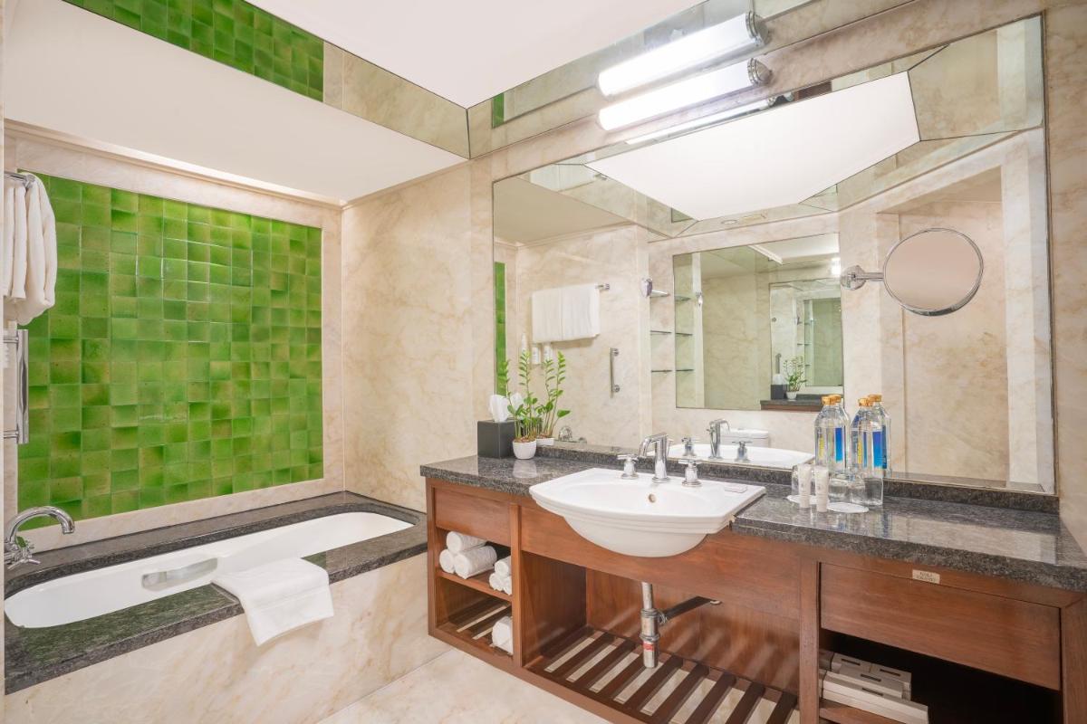 a bathroom with a sink and a mirror at Hyderabad Marriott Hotel & Convention Centre in Hyderabad