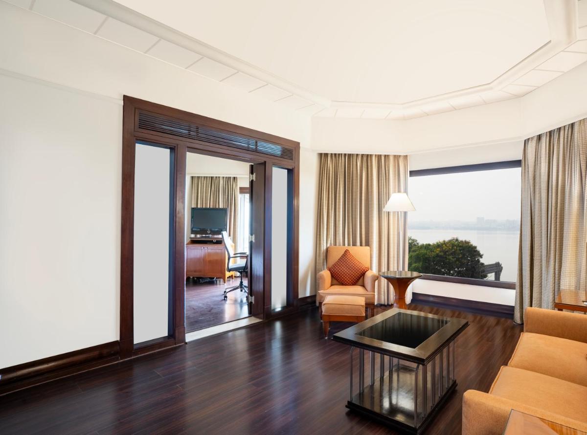 a living room with a couch and a table at Hyderabad Marriott Hotel & Convention Centre in Hyderabad