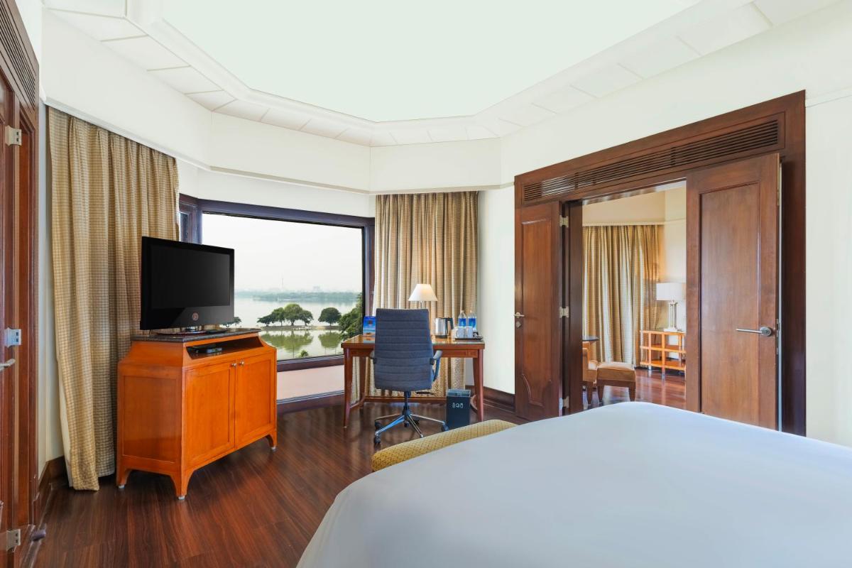 a hotel room with a bed and a flat screen tv at Hyderabad Marriott Hotel & Convention Centre in Hyderabad
