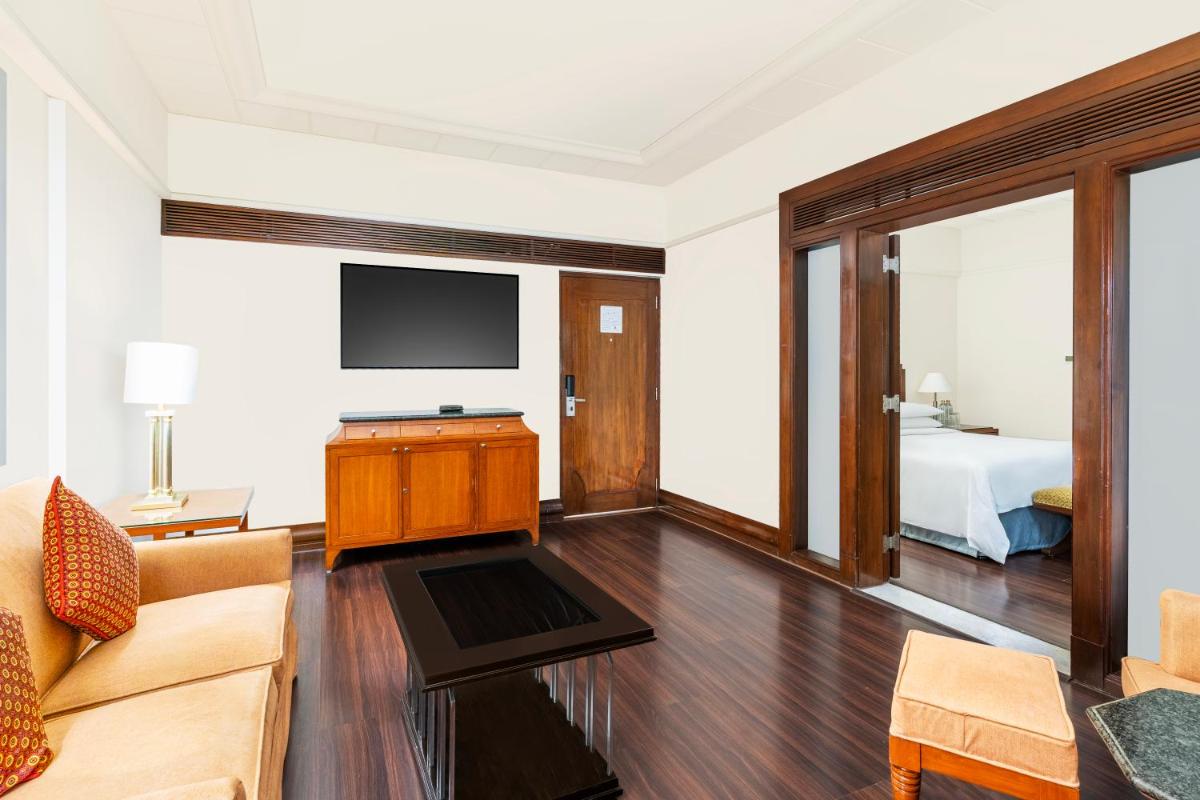 a living room with a couch and a tv at Hyderabad Marriott Hotel & Convention Centre in Hyderabad
