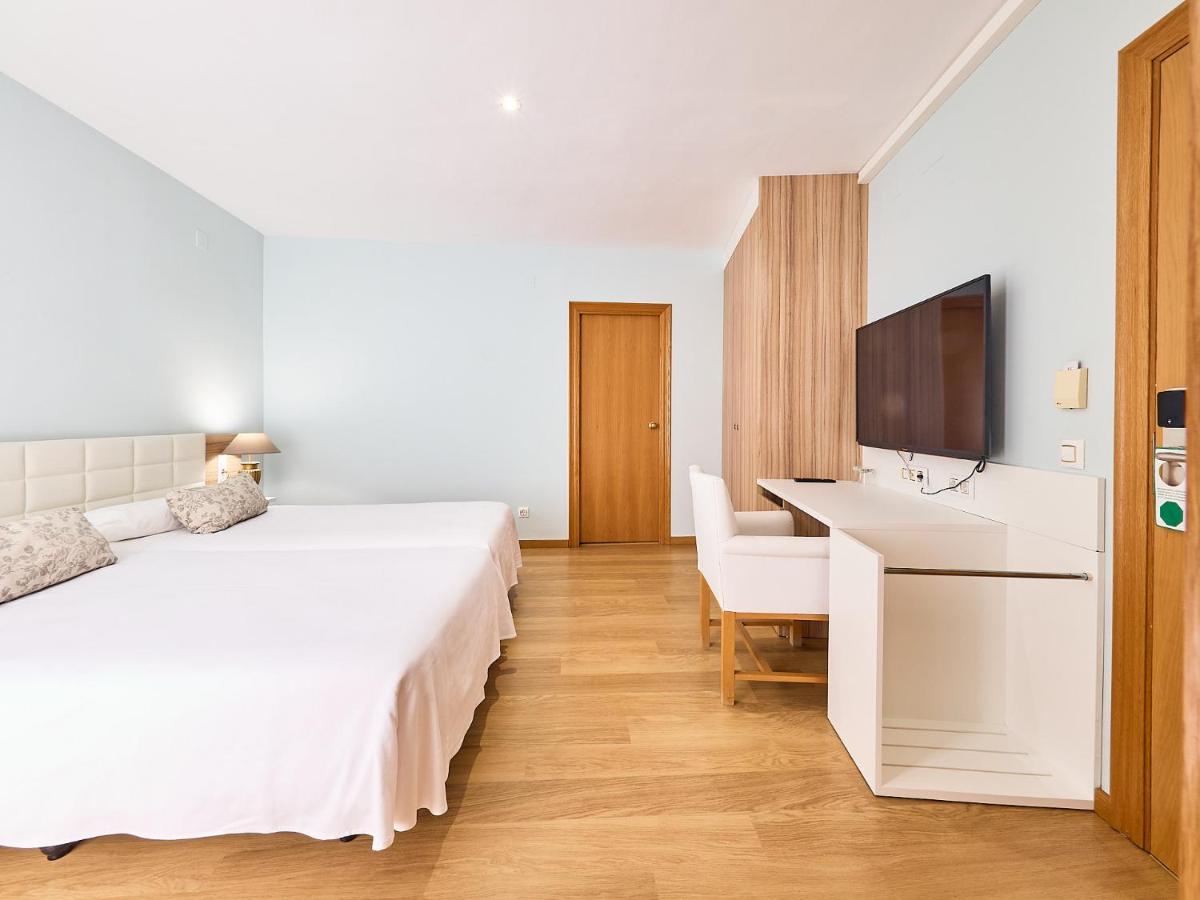 Cama o camas de una habitación en Mònica Hotel