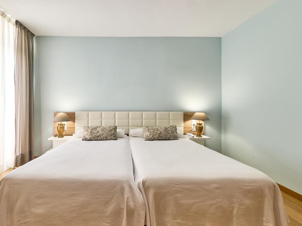 Cama o camas de una habitación en Mònica Hotel
