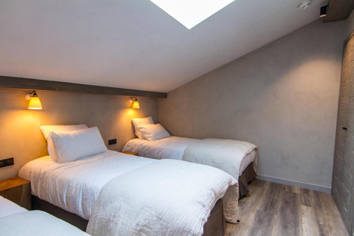 Un ou plusieurs lits dans un hébergement de l'établissement Hôtel de la Roche