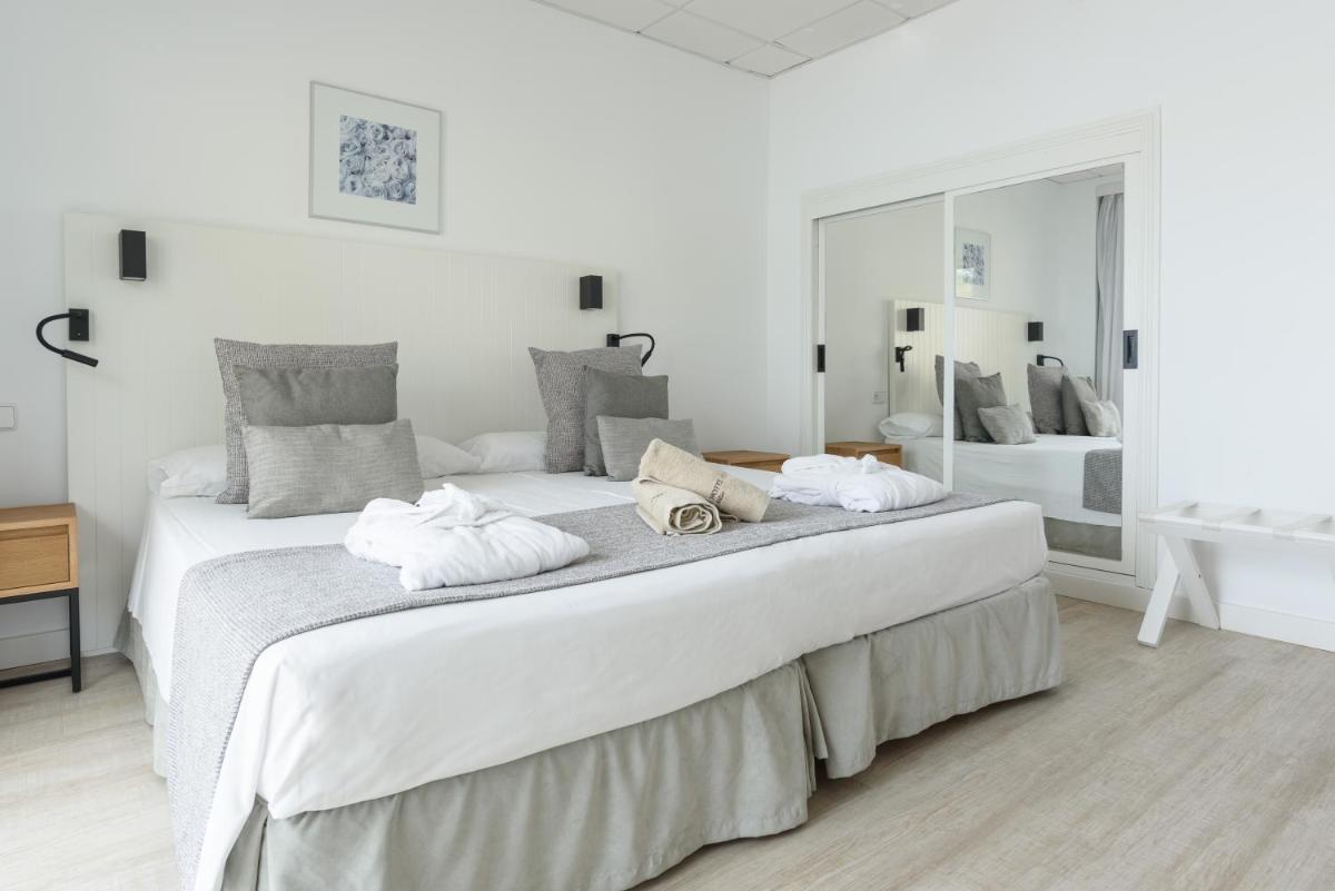Cama o camas de una habitación en Hotel Marina