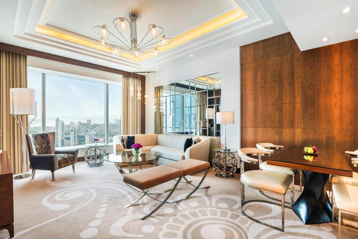 a living room with a couch and a table at The St. Regis Mumbai in Mumbai
